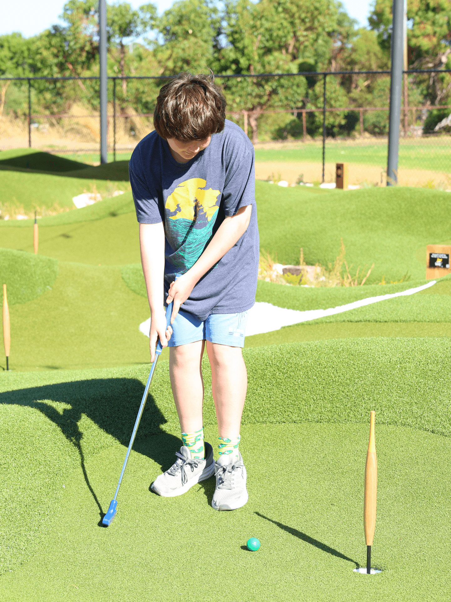 Child Playing Mini Golf at OuttaBounds Child playing mini golf at OuttaBounds