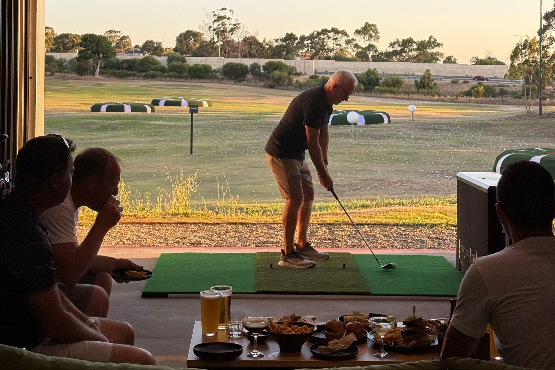 Guests eating, drinking and playing golf at OuttaBounds