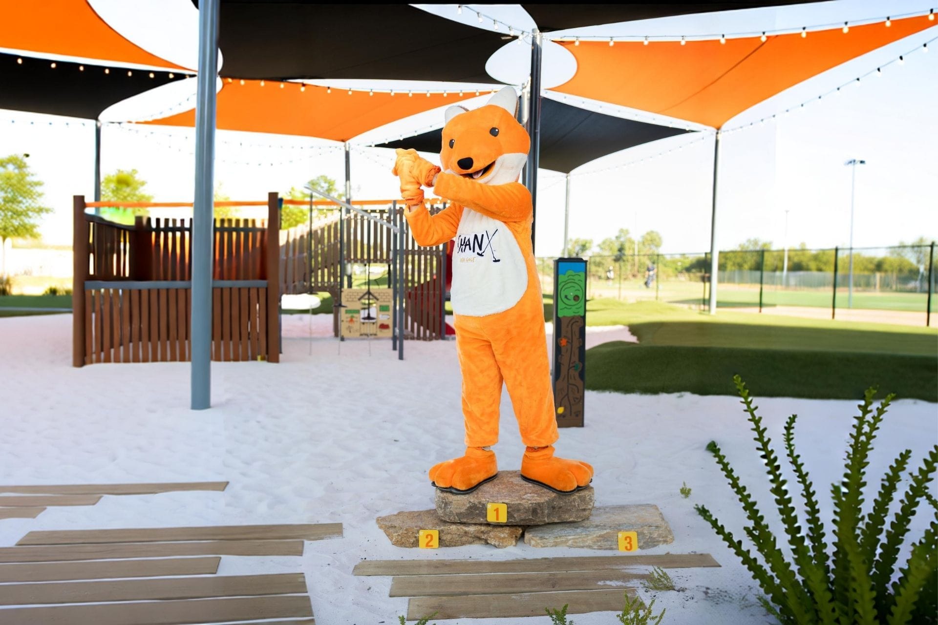 Rox the Fox playing mini golf Mini golf course with rolling hills, sand dunes and shade sails