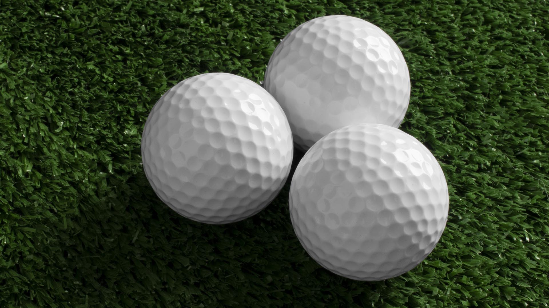 Multiple golf balls on putting green