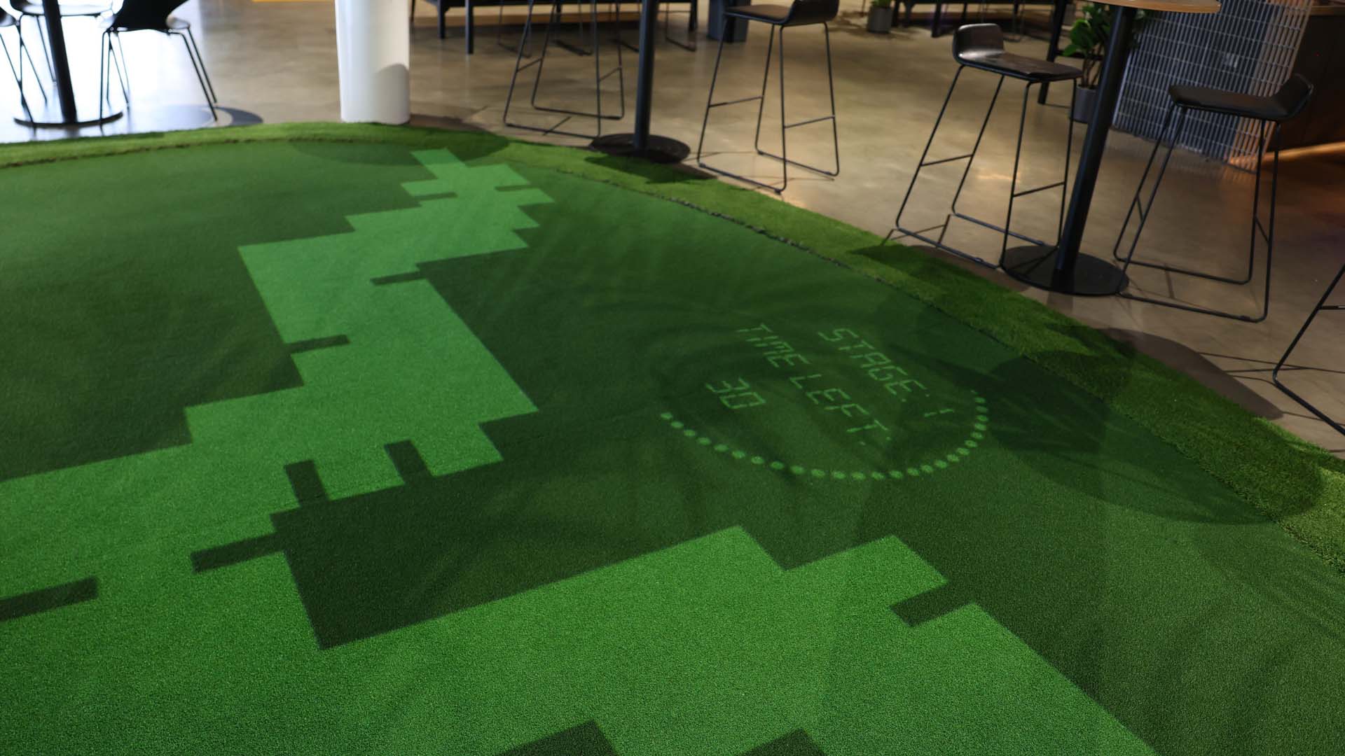 Maze projected onto interactive putting green