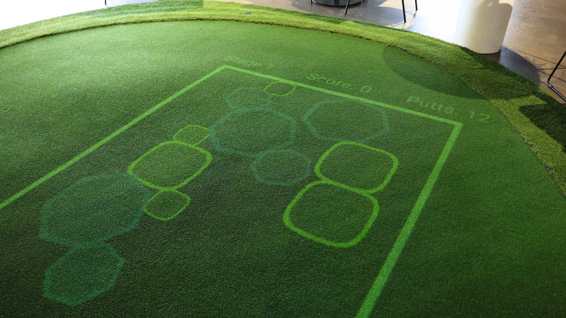 Splash game projected onto interactive putting green