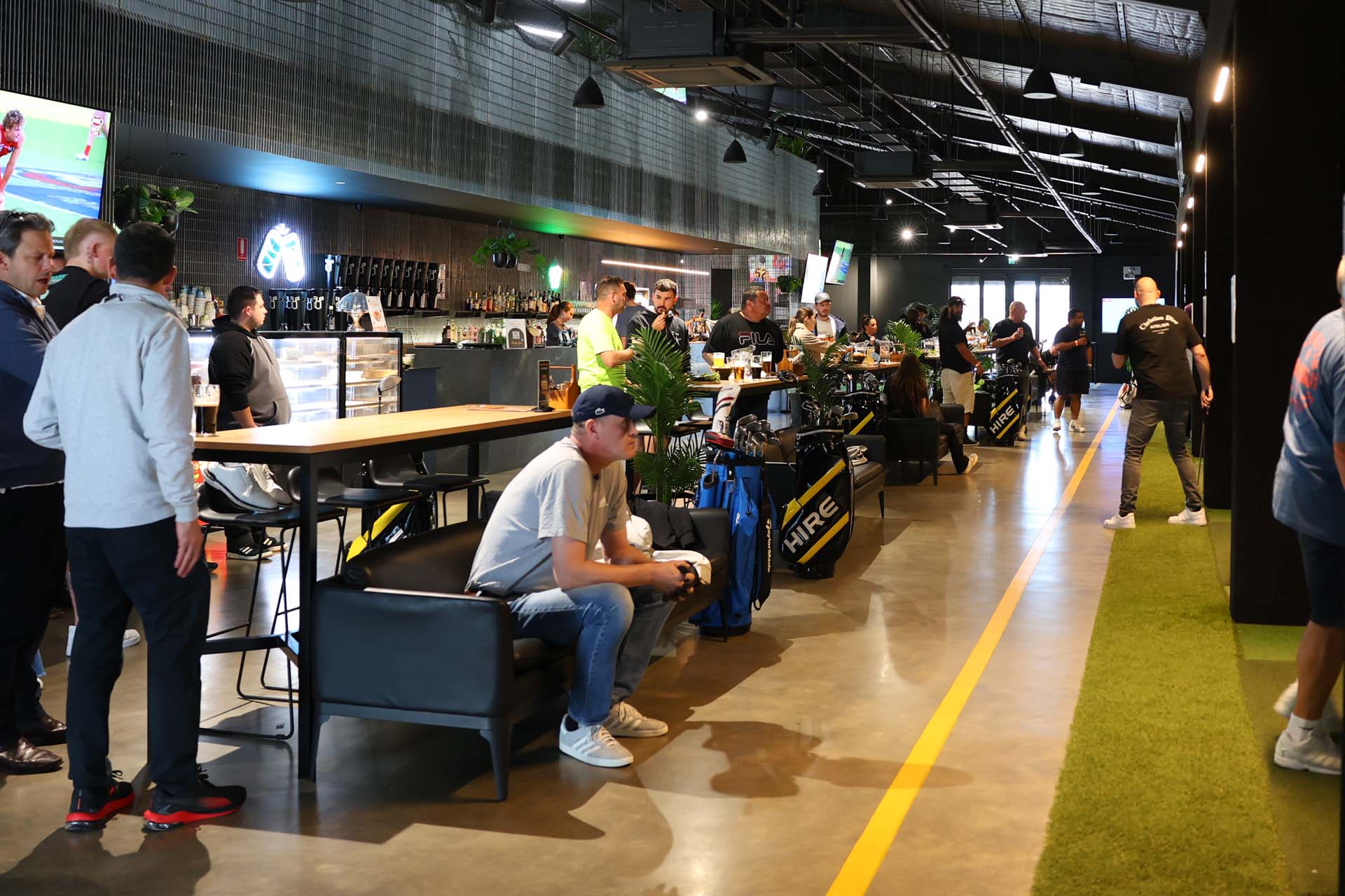 Exclusive-Venue-Hire-Perth-OuttaBounds-10 Guests enjoying indoor bar and golf area of OuttaBounds
