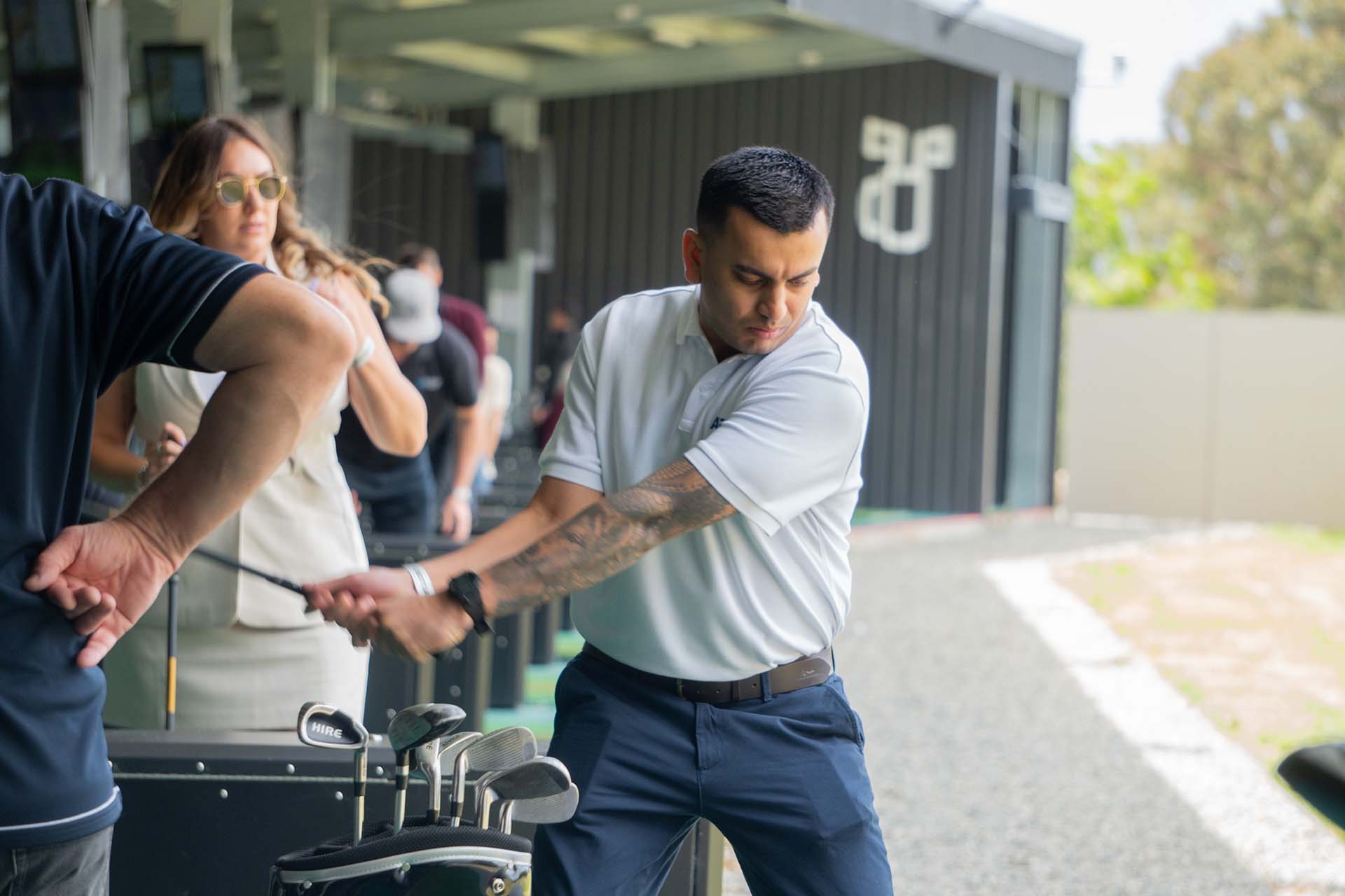 Guest playing the outdoor golf range at OuttaBounds during an exclusive lockout event