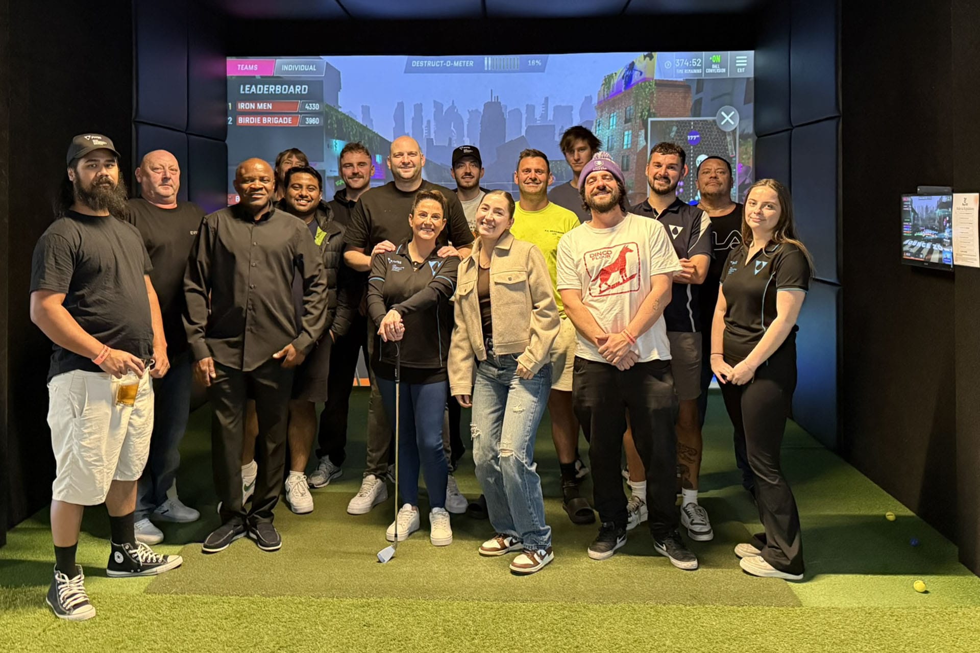 Group at golf simulators at OuttaBounds