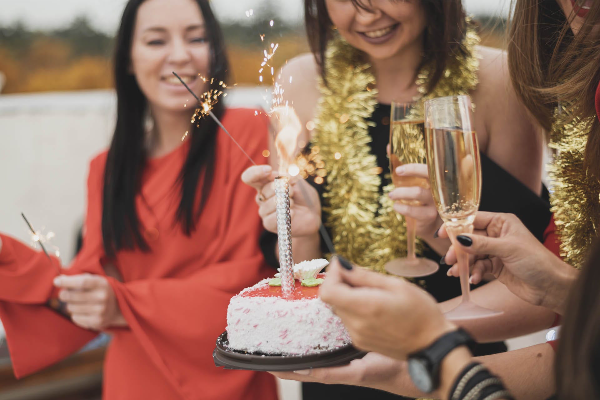 Ladies enjoying birthday with birthday cake and champaign