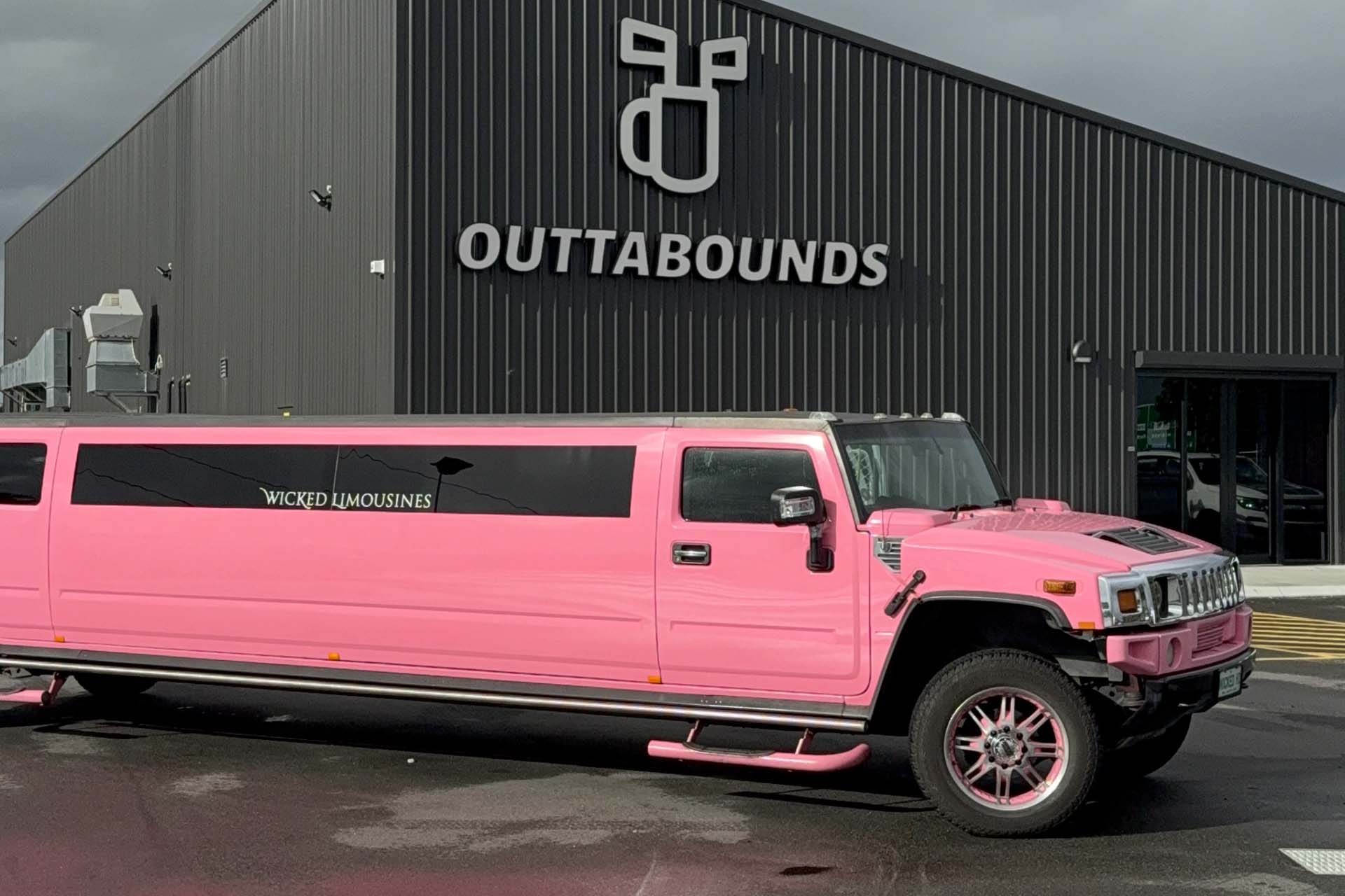 Hens-bucks-party-outtabounds-header Pink Limo Outside OuttaBounds in the Parking Area