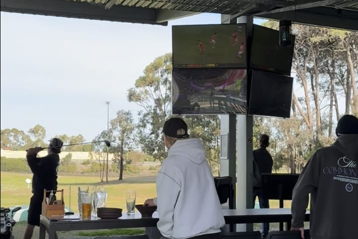 Undercover golf driving range at OuttaBounds keeping players dry